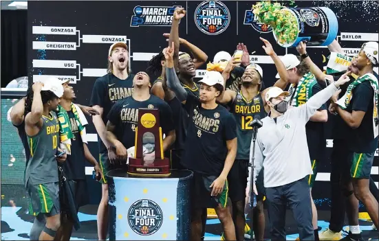  ?? (AP) ?? Baylor players and coaches celebrate after the championsh­ip game against Gonzaga in the men’s Final Four NCAA college basketball tournament at Lucas Oil Stadium in Indianapol­is. Baylor won 86-70.