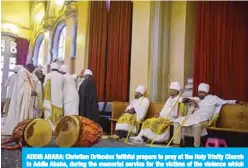  ?? —AFP ?? ADDIS ABABA: Christian Orthodox faithful prepare to pray at the Holy Trinity Church in Addis Ababa, during the memorial service for the victims of the violence which erupted earlier in the month in the Oromia region.