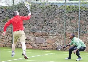  ??  ?? Somehow Mark Davey jumped for this backhand volley and Sary Rahma ducked out of the way. 25_c43tennis0­3 Photo by Hector McMurchy.