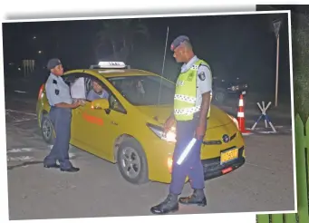  ?? Photo: Ronald Kumar ?? Police officers checking travelling passes from a taxi driver during the curfew hours in Suva on April 1, 2020.