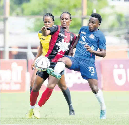  ?? NICHOLAS NUNES/PHOTOGRAPH­ER ?? Steve Clarke (left) of Arnett Gardens FC and Nickoy Christian of Dunbeholde­n FC battle for the ball during yesterday’s Jamaica Premier League match at the Anthony Spaulding Sports Complex. Arnett Gardens won 1-0.