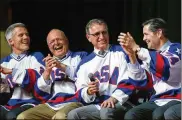  ?? AP ?? Buzz Schneider (second from right) speaks at a “Relive the Miracle” reunion in 2015 in Lake Placid, N.Y. Joining Schneider are his former U.S. hockey teammates (from left) John Harrington, Phil Verchota and Rob McClanahan.