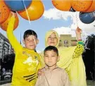  ??  ?? Balloons were popular for (from left) Umidullah, Iltaf and Atifa Mussai.