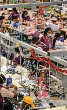  ?? Bloomberg/Dwayne Senior ?? Production line: Workers sew garments at the Prestige Clothing factory, operated by TFG in the Maitland district of Cape Town