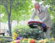  ??  ?? Prince Charles lays a wreath at the VJ Day service