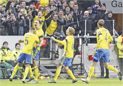  ??  ?? SOLNA: Sweden’s forward and team captain Zlatan Ibrahimovi­c (2ndL) celebrates with teammates after scoring a goal during the Euro 2016 play-off football match between Sweden and Denmark at the Friends arena in Solna on Saturday. — AFP