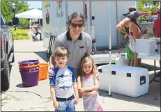  ?? (NWA Democrat-Gazette/Carin Schoppmeye­r) ?? Will Clark, with his children Charlie and Mary, help support the Children’s Safety Center.