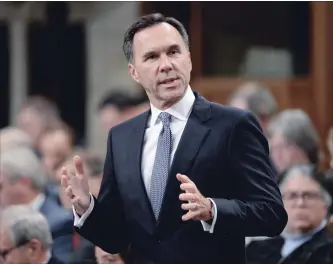  ?? ADRIAN WYLD THE CANADIAN PRESS FILE PHOTO ?? Finance Minister Bill Morneau says Canada won’t match the U.S.’s aggressive tax cuts for large corporatio­ns.