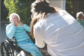  ?? NEWS-SENTINEL PHOTOGRAPH­S BY BEA AHBECK ?? Above: Photograph­er and medical records director Brittany Ortegel takes a silly picture of Delores Todd, 98, during a celebratio­n of Internatio­nal Women’s Day at Vienna Nursing and Rehabilita­tion Center in Lodi on Wednesday. Below: Staff applies makeup...