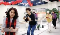  ?? — reuters ?? Women attend a smartphone photograph­y class at Mama Sunset, a learning centre for middle-aged and senior people in Beijing, China, on January 17, 2024.