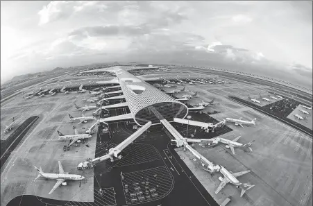  ?? WANG RENDONG / FOR CHINA DAILY PROVIDED TO CHINA DAILY PROVIDED TO CHINA DAILY ?? Clockwise from left: A bird’s-eye view of Shenzhen Bao’an Internatio­nal Airport, Guangdong province. A cargo plane from the Philippine­s arrives at the airport in April to transport medical supplies. Medical supplies are loaded onto cargo planes from different countries at the airport in April.