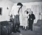  ??  ?? Diane Arbus’s A Jewish giant at home with his parents in the Bronx, N.Y., a 1970 print from the Emily and Jerry Spiegel Collection, sold for $583,500