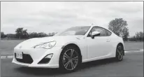  ?? PHOTOS: ALEXANDRA STRAUB, SPECIAL TO THE GAZETTE ?? The 2013 Scion FR-S is fun to drive on the track, but will probably spend most of its time on regular roads. Either way, the VSC Sport mode (control button at right) allows drivers to use some interventi­on from onboard computers to smooth out the drive...