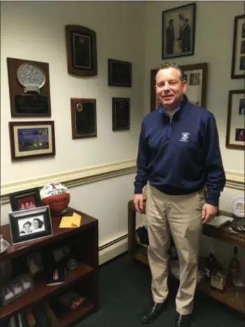  ?? KATHLEEN E. CAREY - DIGITAL FIRST MEDIA ?? Delaware County Republican Chairman Andrew Reilly stands in his SwartzCamp­bell office by the myriad awards he’s received.