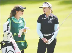  ?? STUART FRANKLIN / GETTY IMAGES ?? Brooke Henderson, right, was always pushing to be
great, says sister Brittany, who is also her caddie.