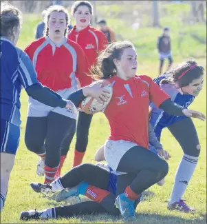  ?? JEREMY FRASER/CAPE BRETON POST ?? Madison MacInnis of the Riverview Rugrats gets tackled during Cape Breton High School Rugby League semifinal action in Membertou on Wednesday. Riverview defeated the Sydney Academy Wildcats 59-0 to advance to the Highland region championsh­ip game...