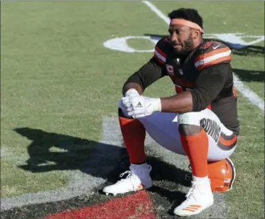  ?? MARK LOMOGLIO — THE ASSOCIATED PRESS ?? Browns defensive end Myles Garrett sits on his helmet as the Tampa Bay Buccaneers celebrate their 26-23 win in overtime Sunday in Tampa, Fla.