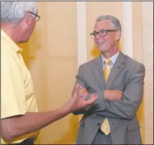  ?? The Sentinel-Record/Mara Kuhn ?? TALKING TOURISM: Kane Webb, director of the Arkansas Department of Parks and Tourism, right, speaks to John Hoefl after Wednesday’s meeting of the Hot Springs National Park Rotary Club at the Arlington Resort Hotel & Spa.