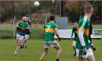  ??  ?? Kilcoole’s James Scullion passes to team-mate Cormac Byrne.