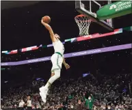  ?? Mary Schwalm / Associated Press ?? Celtics forward Jayson Tatum dunks the ball on a breakaway against the Pelicans on Monday in Boston.