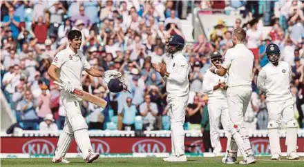  ?? AFP PIC ?? England’s Alastair Cook (left) celebrates his century against India yesterday.