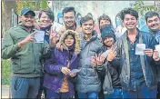  ?? ?? A group of teens after getting Covid-19 vaccine shots show their vaccinatio­n cards at a centre in Prayagraj on Monday.