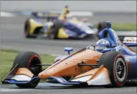  ?? DARRON CUMMINGS — THE ASSOCIATED PRESS FILE ?? In this file photo, Scott Dixon, of New Zealand, heads through a turn during the IndyCar Grand Prix auto race at Indianapol­is Motor Speedway in Indianapol­is. Dixon has blazed his way through the record books to cement himself as the greatest IndyCar driver of his generation. One more championsh­ip will give him five, second in the open wheel record books only to A.J. Foyt.