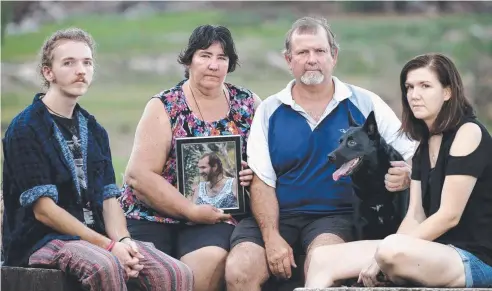  ?? Picture: ANNA ROGERS ?? TRAGIC LOSS: Janice and Graham Bradley (centre) and siblings Michael and Johanna hold a photo of Scott Bradley, who died in an alleged hit-and-run near Mossman last year.