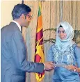  ??  ?? Dr. Wajira Gunasekera presents a certificat­e to a winner