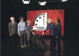  ?? Patrick Semansky Associated Press ?? MEMBERS OF the Bulletin of Atomic Scientists unveil the updated “Doomsday Clock.” Russia’s war in Ukraine is cited as the main reason for the dire prognosis.