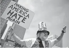  ?? ANDREW CABALLERO-REYNOLDS, AFP/GETTY IMAGES ?? An anti-Trump activist protests outside the Republican National Convention in Cleveland last month.