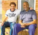  ?? DAN RODRICKS/BALTIMORE SUN ?? Kurt Wenzing, left, and Calvin Ash, who have become friends, sit on the front porch of Ash’s home in Wilson Park in Baltimore.