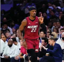  ?? MATT SLOCUM — THE ASSOCIATED PRESS ?? The Heat’s Jimmy Butler, who scored 32points, gestures as he runs down the court during the second half of Thursday’s series-clinching Game 6.