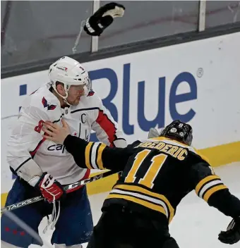  ?? MATT STONE / hErALd STAFF ?? READY TO GO? Boston’s Trent Frederic takes his gloves off to try to fight Washington’s Alex Ovechkin during the third period at TD Garden on Wednesday.