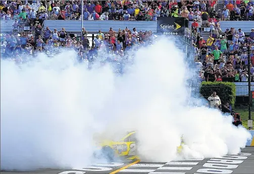  ?? GETTY IMAGES ?? Veteran NASCAR driver Matt Kenseth of Cambridge, Wis., celebrates his unlikely breakthrou­gh victory at Pocono Raceway with a burnout Sunday.
