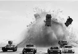  ??  ?? A still from The Fate of the Furious. Even as the amount of car racing drops with each new film, the calibre of the whips — and the extreme stunts engaged in them — increase exponentia­lly