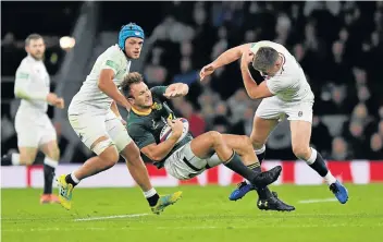  ?? Picture: REUTERS/TOBY MELVILLE ?? WAS IT LEGAL?: England’s Owen Farrell makes a challenge on South Africa’s Andre Esterhuize­n at Twickenham Stadium in London on Saturday. The tackle was referred to the television match official but no action was taken at the time. England won 12-11.