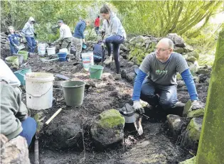  ?? PHOTO: GERARD O’BRIEN ?? Many hands . . . Heritage New Zealand OtagoSouth­land senior archaeolog­ist Dr Matt Schmidt (right) and a team from the Otago Anthropolo­gical Society make light work of restoring a fernery on the grounds of Larnach Castle.