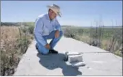  ?? MONTEREY COUNTY HERALD ?? Cattle rancher Joseph Botts Jr. at the burial site of Civil War veteran Cpl. John McBride on the dry lake bed of Lake San Antonio in California.