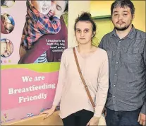  ?? NIKKI SULLIVAN/CAPE BRETON POST ?? Nicole Fraser and husband James Fraser stand beside a sign, located close to the main entrance, that indicates the Cape Breton Regional Hospital is a breastfeed­ing-friendly environmen­t. On Friday, Nicole was videotaped by a stranger while breastfeed­ing...