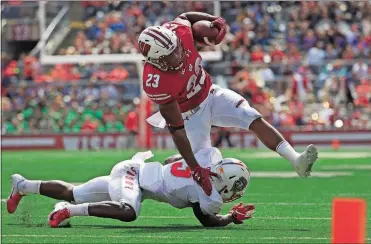  ?? [MORRY GASH/THE ASSOCIATED PRESS] ?? Wisconsin’s Jonathan Taylor runs over New Mexico’s Michael Sewell Jr. during the second half Sept. 8 in Madison, Wis. The Badgers won 45-14.