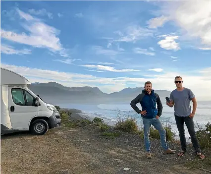  ??  ?? CamperMate founder Adam Hutchinson, left, with German freedom camper Hans Grohe who donated $5 to stay at a campsite near Kaiko¯ ura.