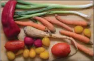  ?? DIGITAL FIRST MEDIA PHOTO ?? Rotten vegetables on a wooden background.