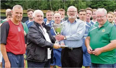  ??  ?? Presentati­on Blantyre Vics’ long-serving official Andy Mcdade receives the Friendship Cup as he hands over the cash donation to Tommy Whitelaw, as Vics manager John Gibson (left) and Celtic secretary Joe Murphy look on (Pic by David Bell)