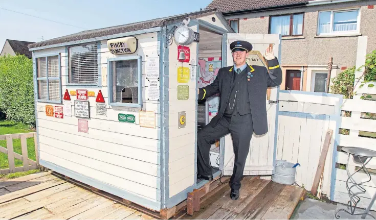  ?? Picture: Paul Reid. ?? Gareth Bell, 27, who has the rare disorder Angelman syndrome, dressed up as a station master outside his specially converted railway shed yesterday.