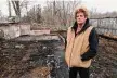  ?? Arnold Gold/Hearst Connecticu­t Media ?? Kelly Cronin, executive director of Kelly’s Kids Inc., stands by the foundation from where her burned down barn stood behind her home in Prospect on Monday.