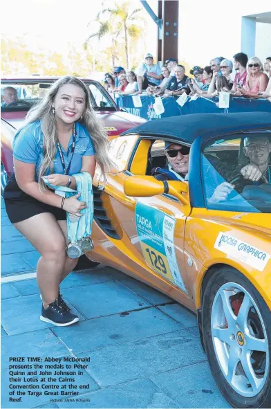  ?? Picture: ANNA ROGERS ?? PRIZE TIME: Abbey McDonald presents the medals to Peter Quinn and John Johnson in their Lotus at the Cairns Convention Centre at the end of the Targa Great Barrier Reef.