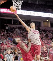  ?? NWA Democrat-Gazette file photo/ANDY SHUPE ?? Arkansas forward Dustin Thomas (center) reaches to score as he collides with forward Adrio Bailey during the Red-White game Oct. 20 at Walton Arena. Thomas is averaging 5.8 points and 5.8 rebounds in 22.0 minutes since coming off a suspension that...