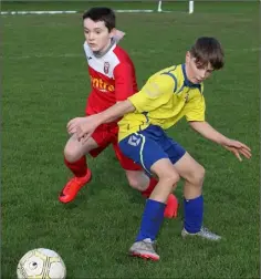  ??  ?? Jack Walsh of New Ross Town is tracked by Dylan Farrell of Moyne Rangers.