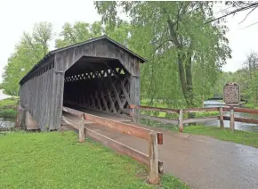  ?? CHELSEY LEWIS/MILWAUKEE JOURNAL SENTINEL ?? The last historic covered bridge in Wisconsin stands in Covered Bridge Park in Cedarburg. Constructe­d in 1876, it was retired in 1962 and is open only to pedestrian traffic.